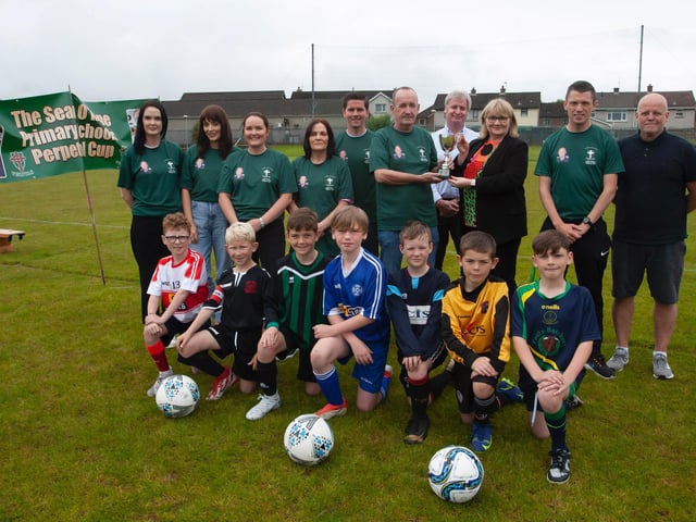 Family members of the late Sean O'Kane presenting the Sean O'Kane Primary Schools Perpetual Cup to Mrs. Martina McCarron, Principal at the school on Tuesday last.