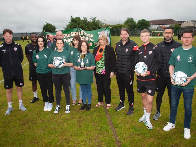 Group pictured at the inaugural Sean O'Kane Primary Schools Perpetual Cup tournament including members of Sean's family including his parents, Derry City manager Ruaidhri Higgins, City players and Mrs. Martina McCarron, Principal.