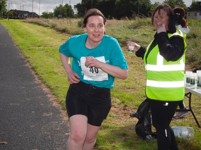 "I don't need water, I need the finish line!" - laughs Caroline Morewood as she makes her way to the finish line on Sunday. (Photo: Jim McCafferty)
