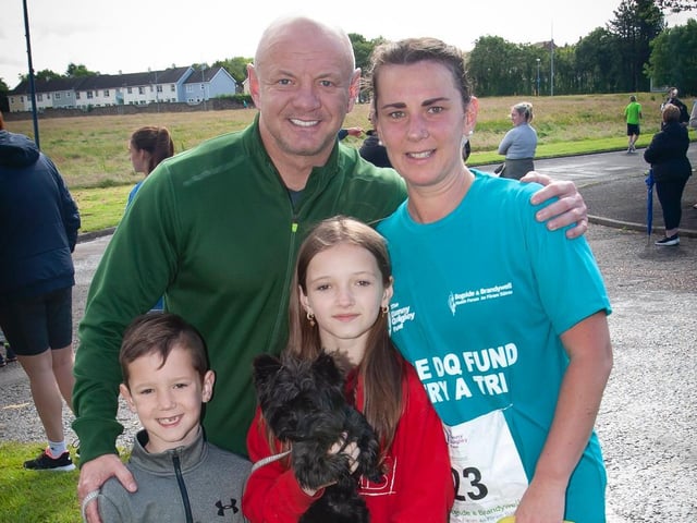 A very proud Liam McLaughlin and family welcomes his wife, Kate, home after Sunday's Triathlon. (Photo: Jim McCafferty)