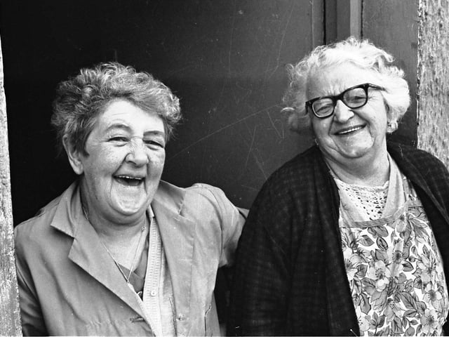 1972... Two Bogside ladies smile for the camera during the removal of barricades in the district.