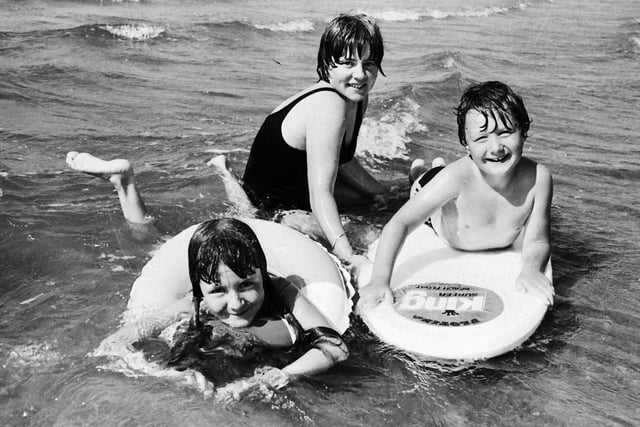 1977... Enjoying a cooling dip during the hot weather at Lisfannon are Rhonda, Maxine and Alan Miller, from Newbuildings.