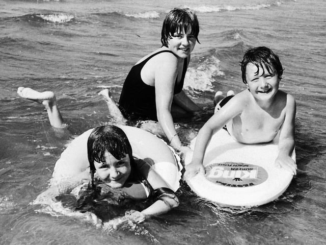 1977... Enjoying a cooling dip during the hot weather at Lisfannon are Rhonda, Maxine and Alan Miller, from Newbuildings.