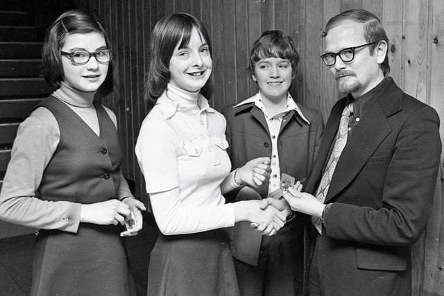 1977... Eric Sweeney, adjudicator, presents the winner's medal in the Moore's Melodies competition (13-14 years) to Yvonne O'Leary. Second from right is Paul Murphy, runner-up and, on left, Mary Grant, who was third.