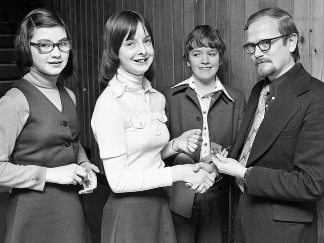 1977... Eric Sweeney, adjudicator, presents the winner's medal in the Moore's Melodies competition (13-14 years) to Yvonne O'Leary. Second from right is Paul Murphy, runner-up and, on left, Mary Grant, who was third.