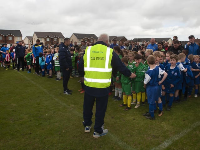 Teams lined up to pick up their medals after Sundayâ€TMs soccer tournament at Oakland Park in Creggan, Derry.