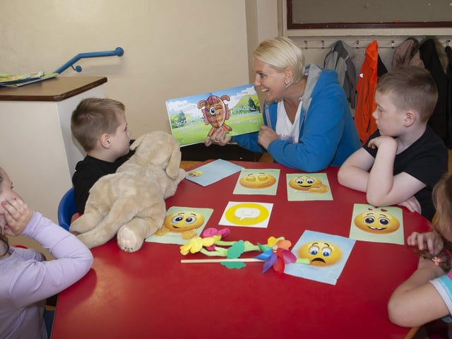 â€ ̃Fresh Little Mindsâ€TM facilitator Mary Fitzpatrick working with some of the children at Holy Child PS.