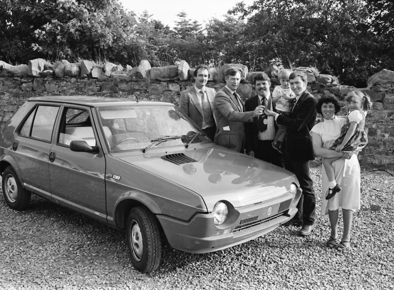 A Buncrana Youth Club draw for a Fiat Ritmo car was won by two-year-old Jonathan Lynch whose name had been entered by his father Daniel. Mr. P.J. Hallinan, chair of the Youth Club, is pictured presenting the keys to Jonathan being held by his father, with, on right, Mrs. Sheila Lynch with daughter Brenda and centre, Mr. Bernard Griffin, the ‘Mayor of Buncrana’ and, on left, Mr. Danny Kelly, Farren’s Garage, Buncrana, who supplied the car.