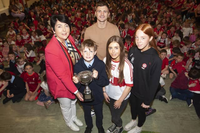Ms. Teresa Duggan, Principal, Hollybush PS pictured handing over the Magee Cup to Jack McGee for consideration of others and parish and community involvement at the Annual School Prizegiving last week. Included are special guests Conor 'The Kid' Coyle with Annie Duffy and Rosa Gallagher, two All-Ireland winning past pupils. (Photos: Jim McCafferty Photography)