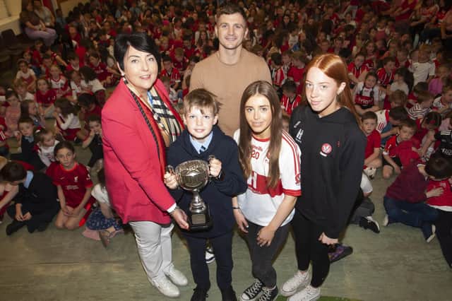 Ms. Teresa Duggan, Principal, Hollybush PS pictured handing over the Magee Cup to Jack McGee  for consideration of others and parish and community involvement at the Annual School Prizegiving last week. Included are special guests Conor 'The Kid' Coyle with Annie Duffy and Rosa Gallagher, two All-Ireland winning past pupils. (Photos: Jim McCafferty Photography)