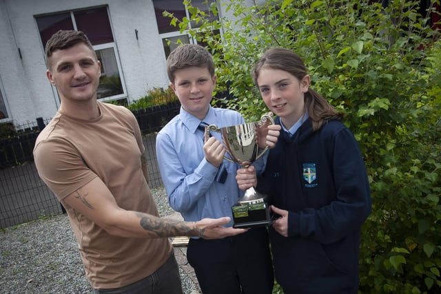 Ronan Doherty and Jane Tankred, joint winners of the Patsy McChrystal Overall Sports Person of the Year award receiving their trophy from Conor Coyle.