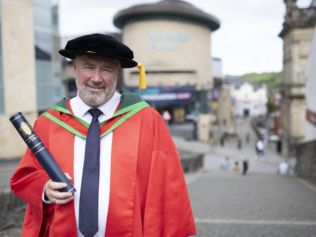 honorary graduate, John Shiels, Chief Executive of Manchester United Foundation, who was also conferred in Derry.(Photo: Nigel mcDowell/Ulster University)