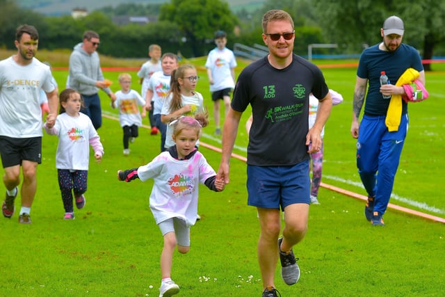 Getting a helping hand during the Adam B Charity Children’s Colour Run underway at the Templemore Sports Complex on Saturday afternoon last. Photograph: George Sweeney.  DER2227GS – 016