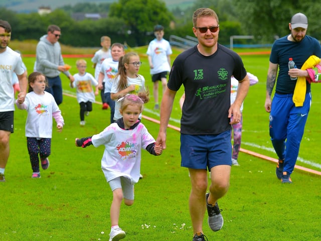 Getting a helping hand during the Adam B Charity Children’s Colour Run underway at the Templemore Sports Complex on Saturday afternoon last. Photograph: George Sweeney.  DER2227GS – 016