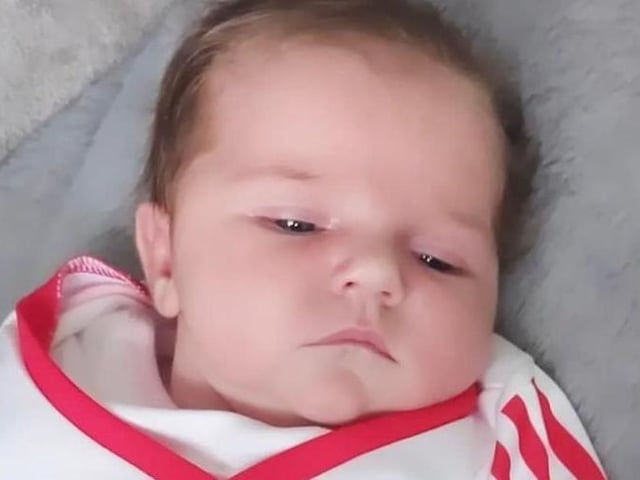 Three weeks old Alara Grace Divin wearing her Derry colours.