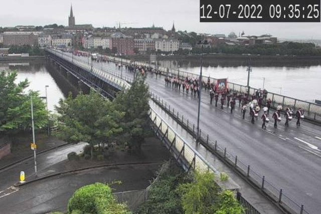 Orangemen make their way back across the bridge to May Street to board buses for Limavady.