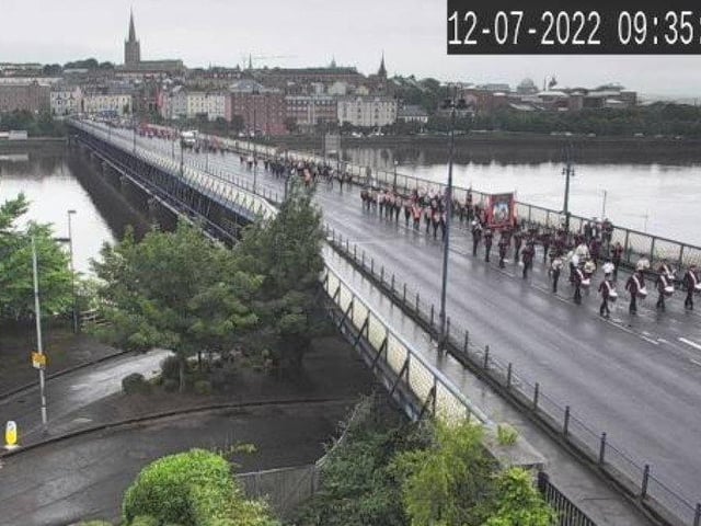 Orangemen make their way back across the bridge to May Street to board buses for Limavady.