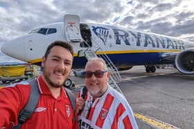 Ethan Barr and his father Michael pictured about to board their flight from Dublin to Riga on Wednesday afternoon.