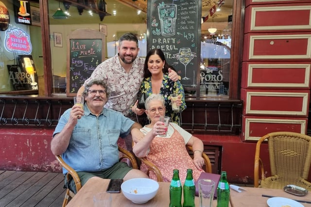 The Higgins family pictured enjoying a drink as they gather in Riga for Derry City's big game.