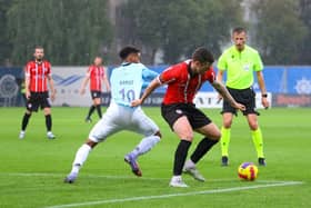 Patrick McEleney and Riga goalscorer Gabriel Ramos get to grips with each other in the rain in Riga. Photograph by Kevin Moore.