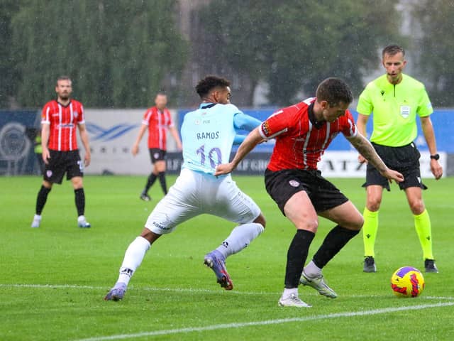 Patrick McEleney and Riga goalscorer Gabriel Ramos get to grips with each other in the rain in Riga. Photograph by Kevin Moore.