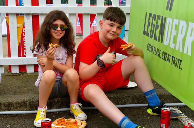 Enjoying a pizza at the Legenderry Street Food Festival held along the Foyle Embankment over the weekend. Photo: George Sweeney. DER2228GS – 034