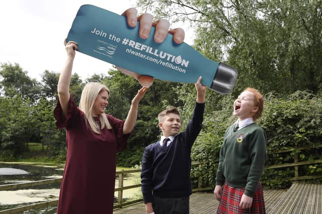 Sara Venning, Chief Executive of Northern Ireland Water, with pupils Jude Semple from Fairview Primary School and Autumn McFarland from Donaghadee Primary School, launching the Refillution campaign in 2019.