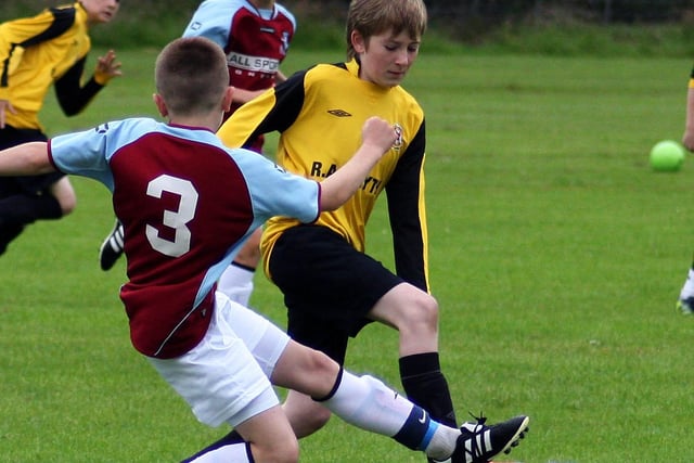 Limavady United’s Joshua Galloway, slips over a tackle from Donegal Town’s Sean Breen, In their Foyle cup under 12 game at Eglinton.  INLS 12230-504MT.