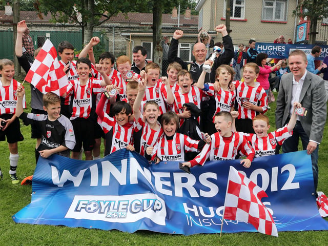 ©/Lorcan Doherty Photography -  July 21th 2012. Hughes Insurance Foyle Cup U-12 Plate Final. Derry and District Youth FA V Cavan Monaghan Youth League. Brian McDowell, Head of Sales and Marketing at Hughes Insurance, with the victorious Derry and District Youth League team.Photo Credit Lorcan Doherty Photography