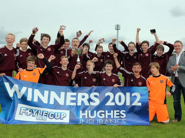 ©/Lorcan Doherty Photography -  July 21th 2012. Hughes Insurance Foyle Cup U-14 Cup Final. Hearts V St. Oliver Plunkett FC (Belfast). Brian McDowell, Head of Sales and Marketing at Hughes Insurance, with the victorious Hearts team.Photo Credit Lorcan Doherty Photography