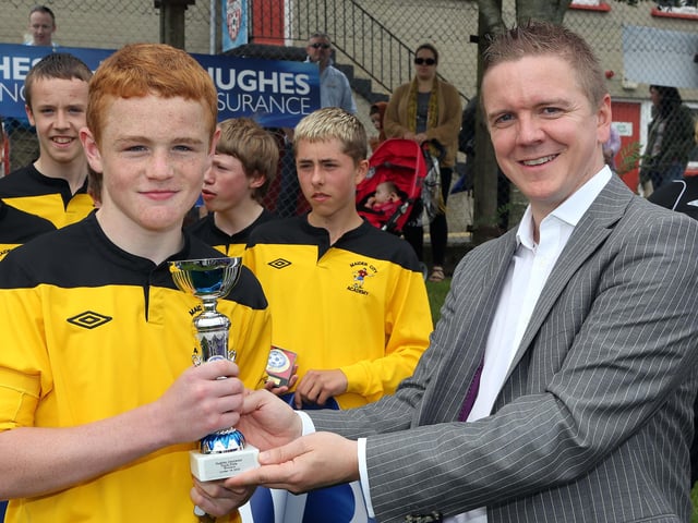 ©/Lorcan Doherty Photography - July 21th 2012.
Hughes Insurance Foyle Cup U-14 Plate Final. Maiden City Academy V Dungoyne (Belfast) Brian McDowell, Head of Sales and Marketing at Hughes Insurance, presenting the Hughes Insurance U-14 Foyle Cup Plate to Brett McGinty, captain, Maiden City Academy, who defeated Dungoyne in the final. Brian McDowell of Hughes Insurance stated: "The Hughes Insurance Foyle Cup is a tournament Derry can be proud of. Hughes Insurance is incredibly proud to be associated with a prestigious tournament that is clearly the premier youth competition in Europe. Everyone involved with the Foyle Cup - from the organisers to the participating teams should take credit for what has been a truly world class football tournament."
Photo Credit Lorcan Doherty Photography