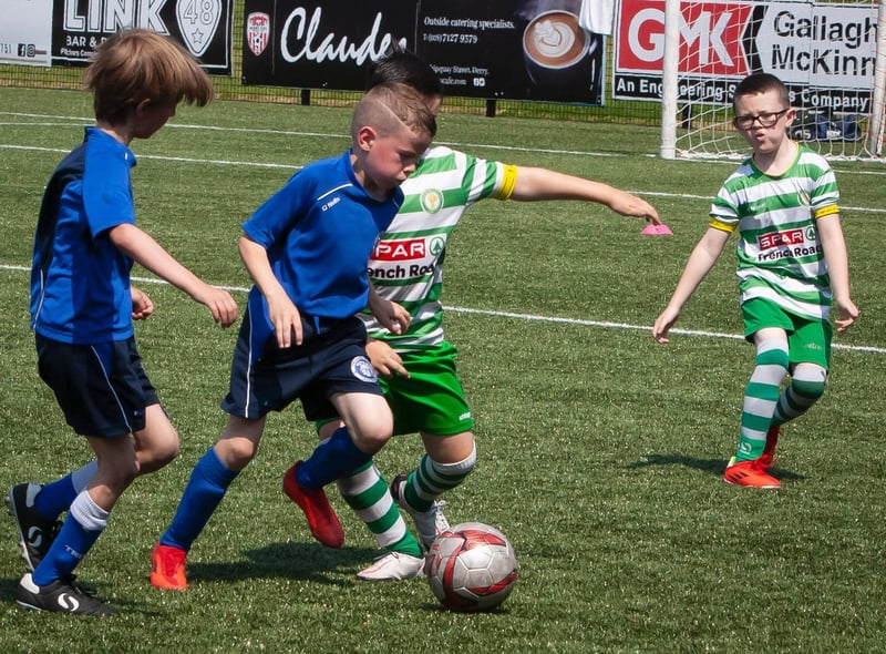 Trojans striker holds off the Top of the Hill Celtic defender during Monday's O'Neill Foyle Cup U8 game. Picture by Jim McCafferty