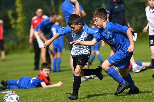 Reece Hargan, Oxford United under-9's in a race for the ball with Ballinamallard United defender Daithi King at Oakgrove on Monday. Picture by Keith Moore