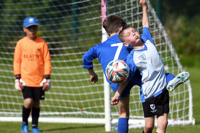Oxford United under-9's striker Michael O'Connor tussles with Ballinamallard United's Alastair McCreesh at Oakgrove 'A' on Monday. Picture by Keith Moore