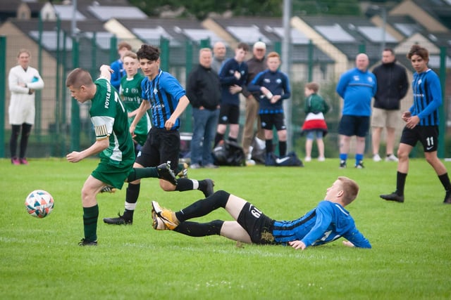 A Foyle Harps player skips away from this challenge from a Portrush midfielder, during their O'Neills Foyle Cup game. Picture by Jim McCafferty