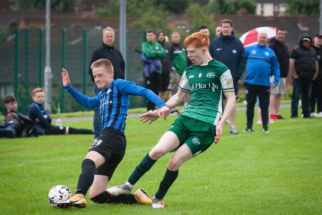 A Portrush player slides in to win possession from a Foyle Harps player during their O'Neills Foyle Cup game. Picture by Jim McCafferty