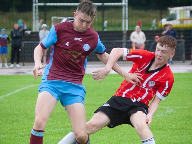 A Tummery player holds off a Derry City player, during their O'Neills Foyle Cup game. Picture by Jim McCafferty
