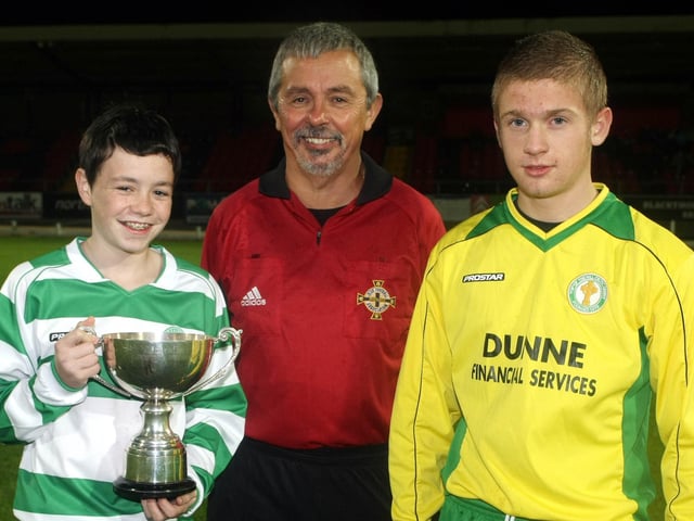 Kierna Duffy, Captain Foyle Harps, with the Michael Curran U14 Cup, after beating TOTHC at the Brandywell Stadium. Also pictured, TOTHC Captain Loughlain Tolland and Referee Charlie Kelpie. (2910GM04)