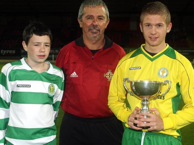 Loughlain Tolland, Captain TOTHC with the Michael Curren U14 Cup, having beaten Foyle Harps at the Brandywell Stadium. Also pictured Foyle Harps Captain Kieran Duffy and Referee Charlie Kelpie. (2910GM03)