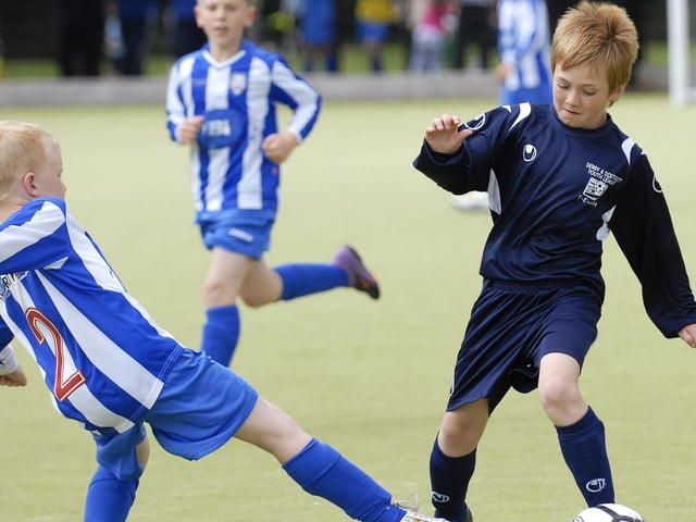 Derry & District Colts under-10's player Jason Logue skips past this challenge from a Coleraine FC defender during their Foyle Cup match. LS30-200KM10