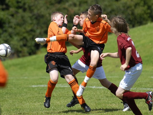 A tussle for the ball during the Foyle Cup match between the Institute and St. Kevin's Boys under-12 sides at Strathfoyle. LS30-192KM10