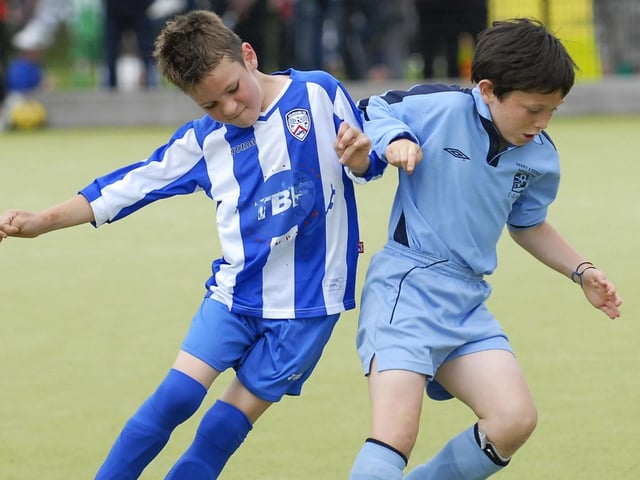 Derry & District Youth League under-10's player Shay Kelly holds off this challenge from a Coleraine Colts defender during their Foyle Cup match. LS30-198KM10