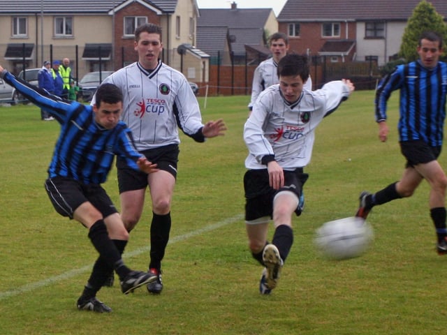 Oxford's Adam Barr manages to fire in a cross despite the close attention of Ballymoor's Sean Duffy and Gavin Kelly during Wednesday's night's u-19 clash in the Foyle Cup at Oakland Park. 2307JM17