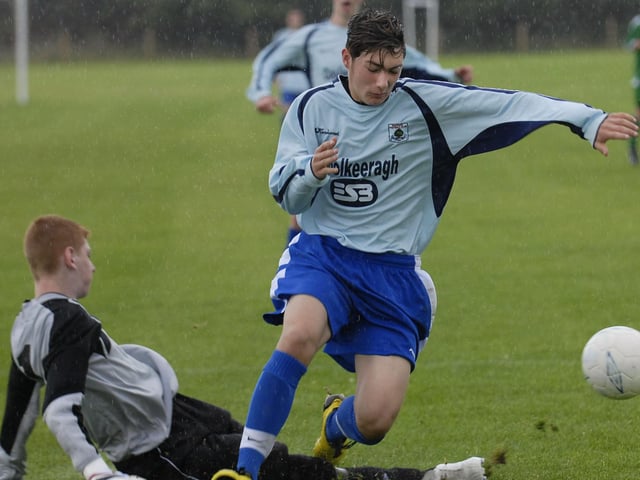 Shankill Youth under-16's goalkeeper slides in to deny Institute striker Dan England during their Foyle Cup match at Clooney Park West. LS30-185KM10