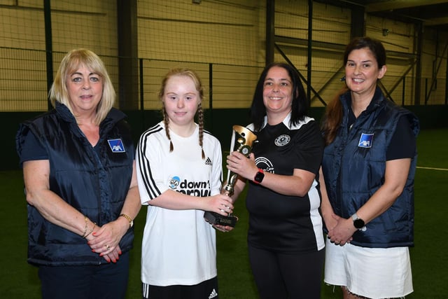 Jessie McMahon of Well Lane Warriors, handing over a trophy to Zara McGavigan, skipper of the Downs & Proud team which took part in the Sports With Disability competition. Included are Pauline Hollywood, AXA Newry Branch Manager, and Helena Casey, AXA Derry Branch Manager.