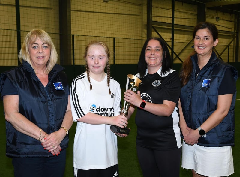 Jessie McMahon of Well Lane Warriors, handing over a trophy to Zara McGavigan, skipper of the Downs & Proud team which took part in the Sports With Disability competition. Included are Pauline Hollywood, AXA Newry Branch Manager, and Helena Casey, AXA Derry Branch Manager.