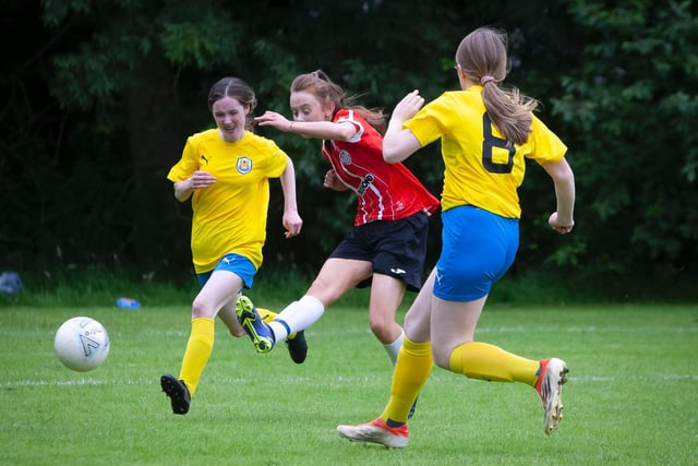 Derry City's Kayleigh Carlin gets her shot away despite the close attention of two Roe Valley defenders.