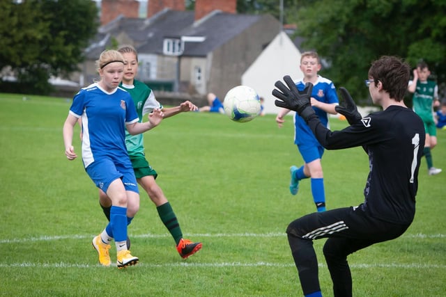 Limavady's Faye McLaughlin carefully heads the ball back to the hands of her goalkeeper during Thursday's Foyle Cup u-13 game against Foyle Harps at Brooke Park, Derry.