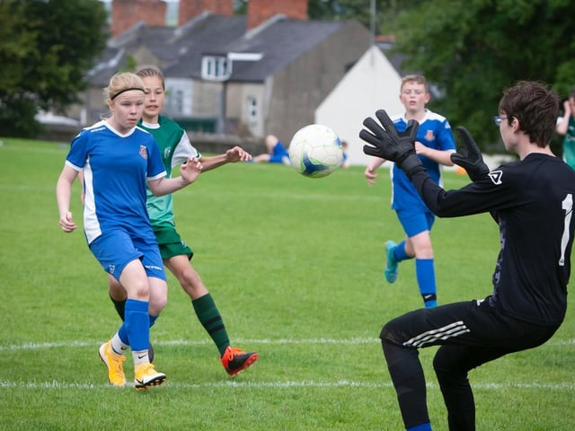 Limavady's Faye McLaughlin carefully heads the ball back to the hands of her goalkeeper during Thursday's Foyle Cup u-13 game against Foyle Harps at Brooke Park, Derry.