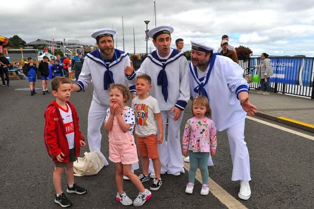 Jamie, Emilie, Harrison and Erin pictured with the singing sailors at the Foyle Maritime Festival. Photo: George Sweeney. DER2229GS – 056
